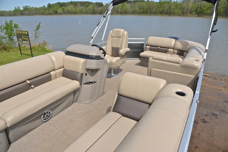 Slide: The Image of 2024 Sun Tracker Party Barge 20 DLX pontoon boat with spacious seating on a serene lake. - 21