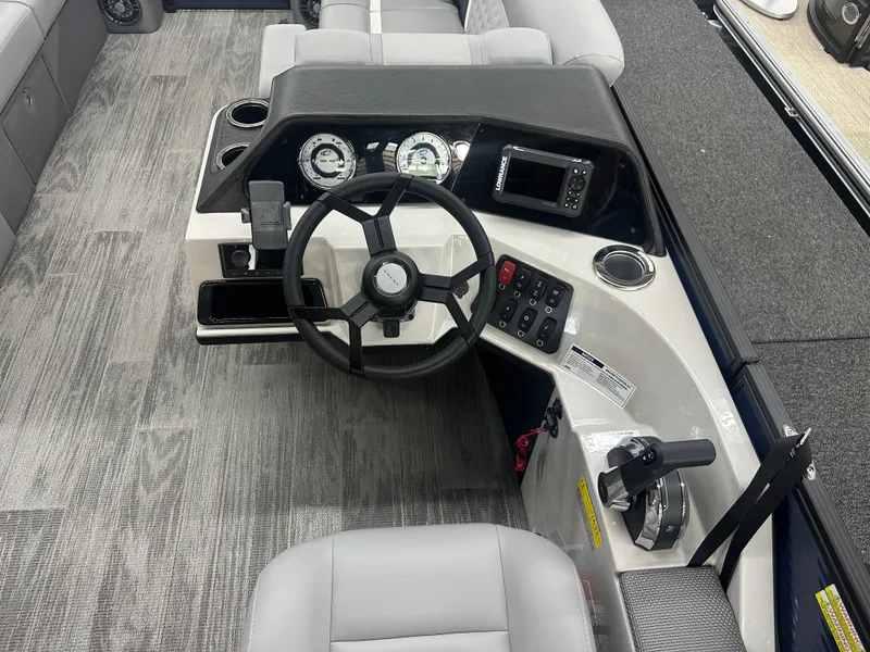 Slide: The Image of 2025 Crest Classic 220 boat dashboard with steering wheel and control panel. - 10