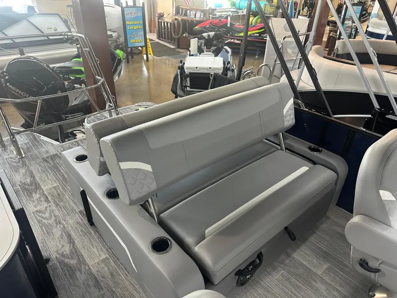 Slide: The Image of 2025 Crest Classic 220 boat interior with gray seating and cup holders. - 11