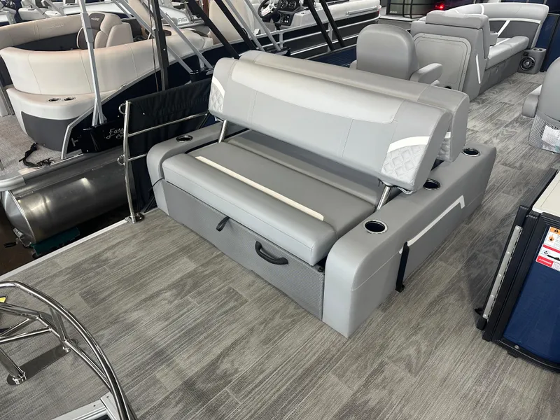 Slide: The Image of 2025 Crest Classic 220 boat interior with gray seating and cup holders. - 13