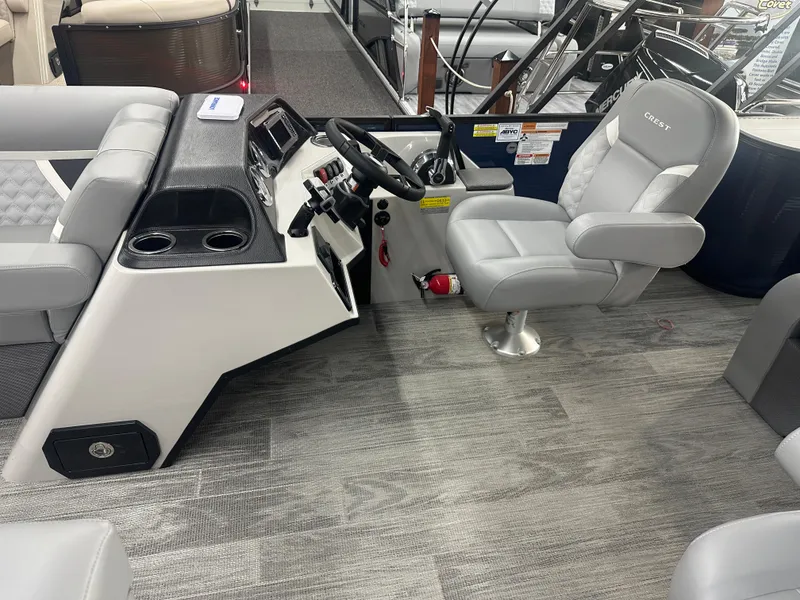 Slide: The Image of 2025 Crest Classic 220 boat interior with modern helm and comfortable seating. - 6