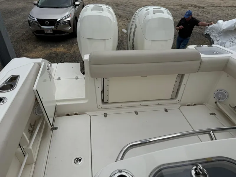 Slide: The Image of 2017 Boston Whaler 280 Outrage boat interior with dual engines and seating area. - 12