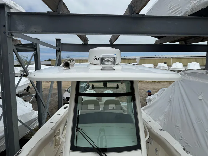Slide: The Image of 2017 Boston Whaler 280 Outrage boat in storage, featuring a sleek design and modern equipment. - 13