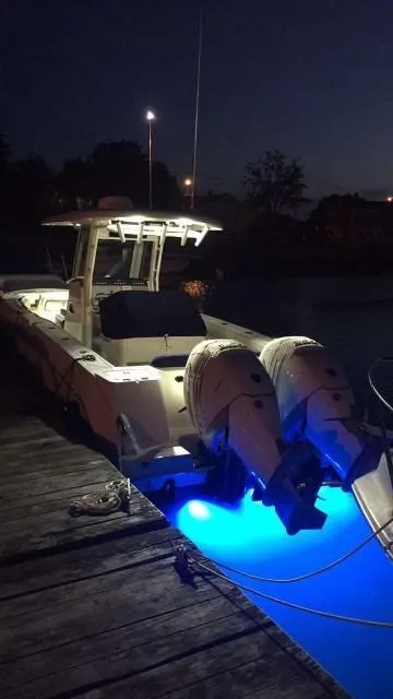 Slide: The Image of 2017 Boston Whaler 280 Outrage with blue underwater lights at night docked. - 15