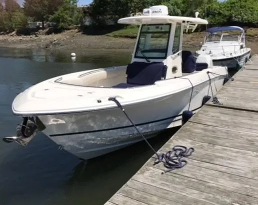 Slide: The Image of 2017 Boston Whaler 280 Outrage docked by a wooden pier in calm waters. - 3