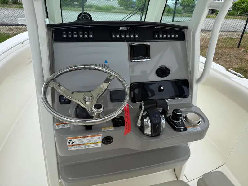 Slide: The Image of 2017 Boston Whaler 280 Outrage helm with steering wheel and control panel. - 4