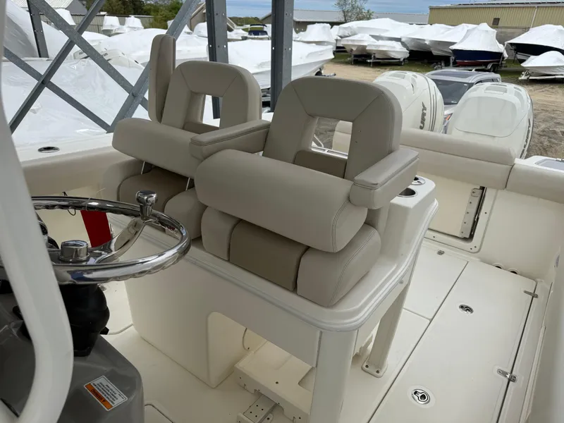 Slide: The Image of 2017 Boston Whaler 280 Outrage boat interior with dual helm seats and steering wheel. - 5
