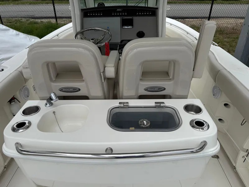 Slide: The Image of 2017 Boston Whaler 280 Outrage boat interior with helm and seating area. - 6