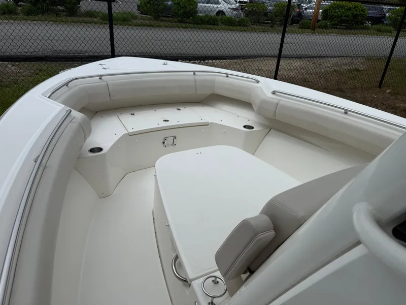 Slide: The Image of 2017 Boston Whaler 280 Outrage boat interior with cushioned seating and storage compartments. - 7