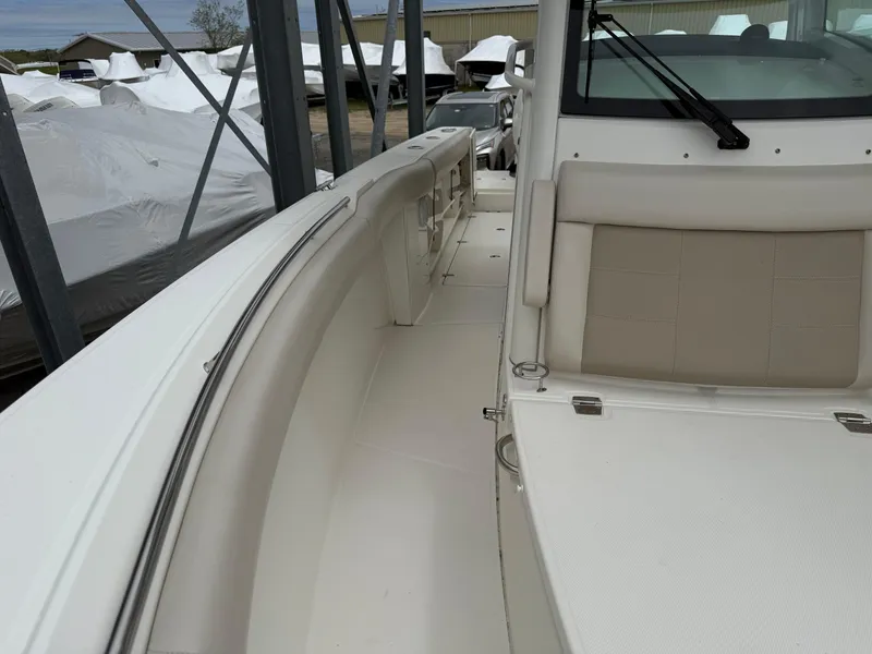 Slide: The Image of 2017 Boston Whaler 280 Outrage boat interior with seating and storage. - 9