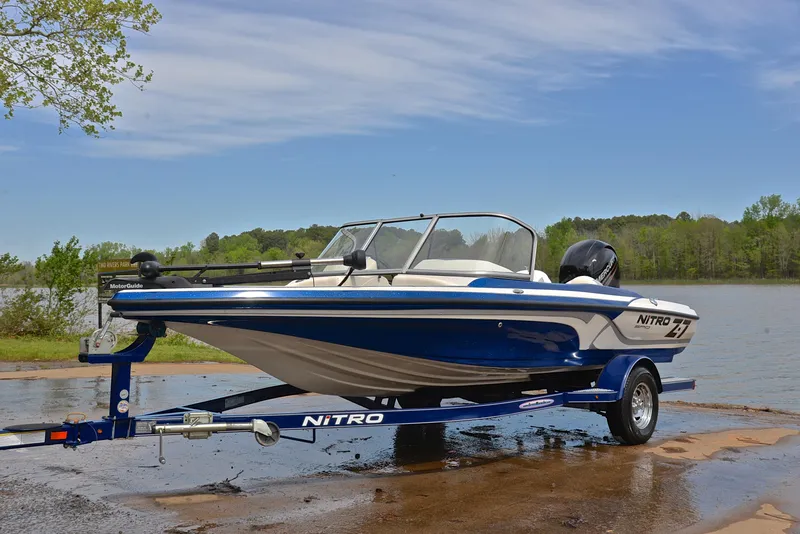 Slide: The Image of 2016 Nitro Z-7 Sport boat on trailer by a lake, under a clear sky. - 10