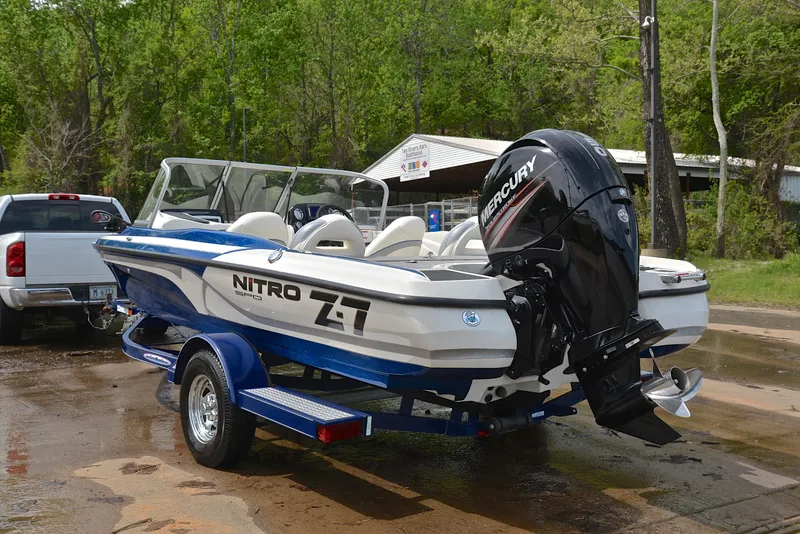 Slide: The Image of 2016 Nitro Z-7 Sport boat with Mercury engine on trailer, parked outdoors. - 12