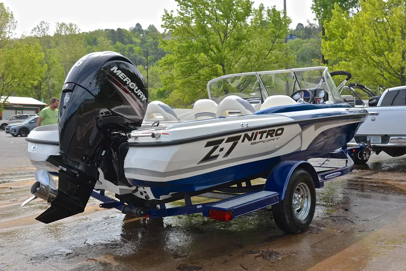 Slide: The Image of 2016 Nitro Z-7 Sport boat with Mercury engine on trailer, parked outdoors. - 14