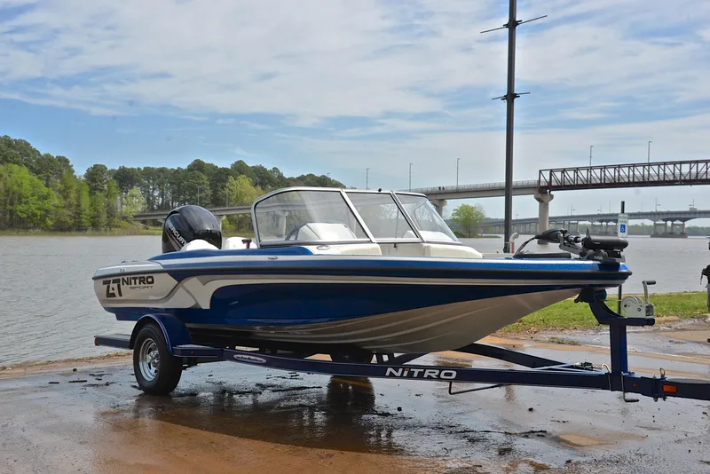 Slide: The Image of 2016 Nitro Z-7 Sport boat on trailer by a lake, ready for launch. - 16