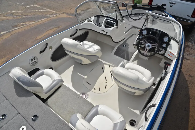 Slide: The Image of 2016 Nitro Z-7 Sport boat interior with white seating and steering console. - 21