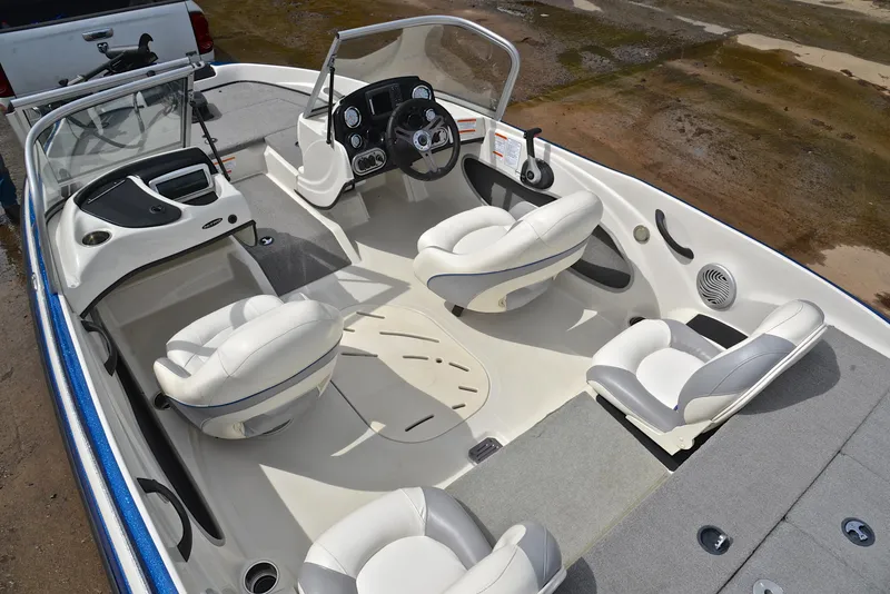 Slide: The Image of 2016 Nitro Z-7 Sport boat interior with white seating and steering console. - 22