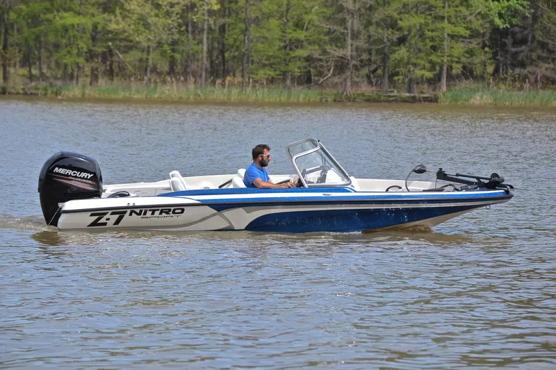 Slide: The Image of 2016 Nitro Z-7 Sport boat cruising on a calm lake with a Mercury engine. - 7