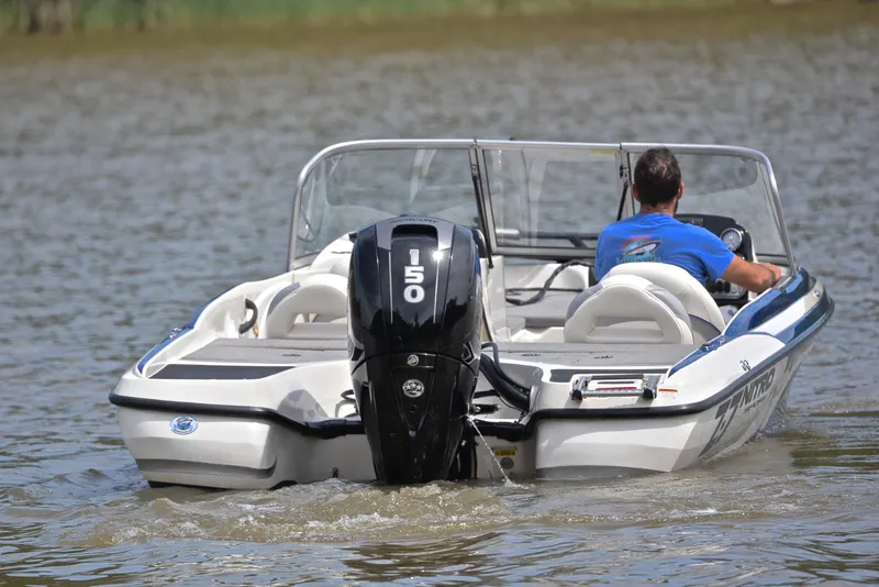 Slide: The Image of 2016 Nitro Z-7 Sport boat on water, rear view with outboard motor. - 8