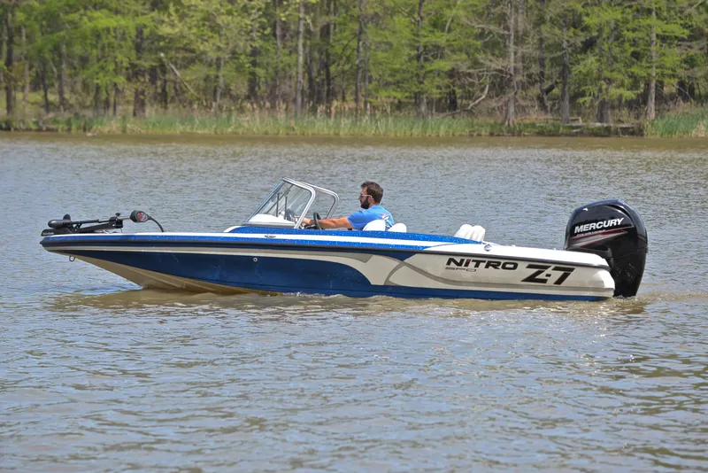 Slide: The Image of 2016 Nitro Z-7 Sport boat cruising on a lake with a Mercury engine. - 9