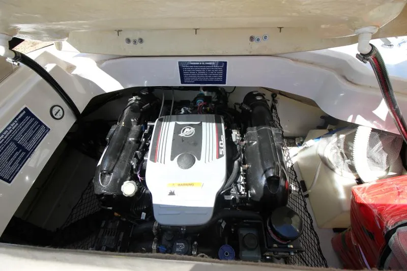 Slide: The Image of 2011 Glastron GLS 215 boat engine compartment with visible engine components. - 10