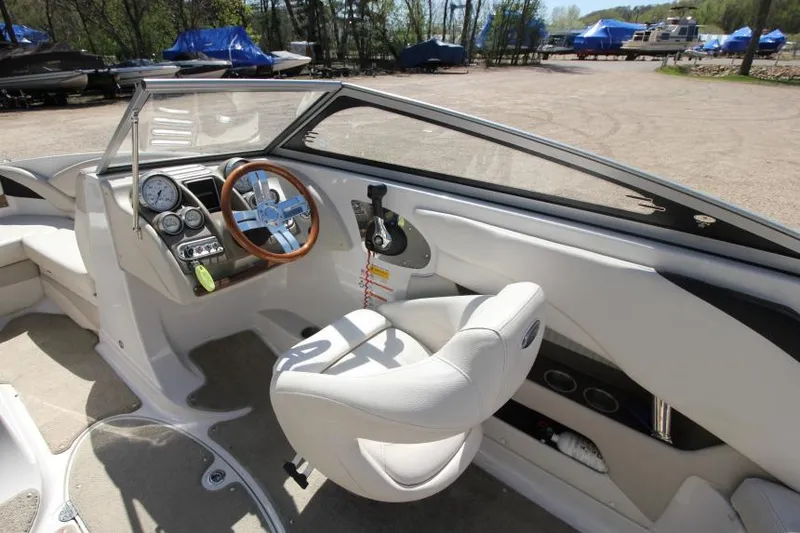 Slide: The Image of 2011 Glastron GLS 215 boat interior with steering wheel and dashboard controls. - 12