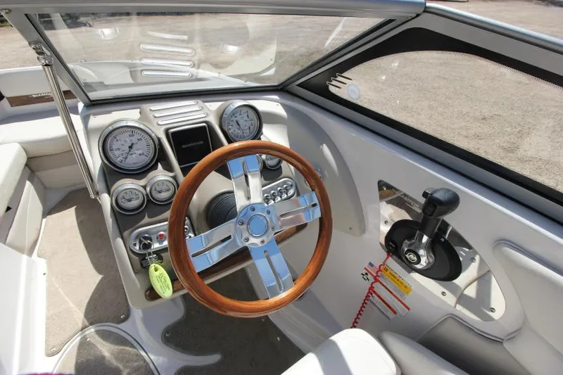 Slide: The Image of 2011 Glastron GLS 215 boat dashboard with wooden steering wheel and instrument panel. - 13