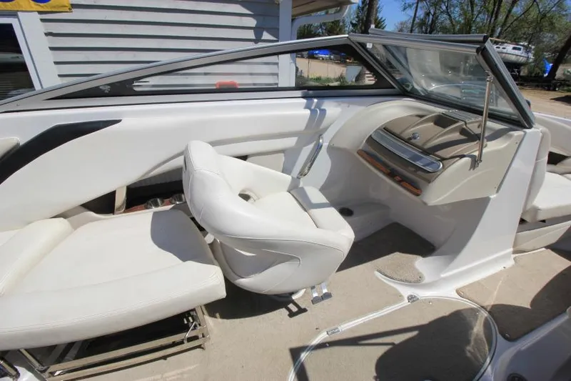 Slide: The Image of 2011 Glastron GLS 215 boat interior with white seating and dashboard. - 15