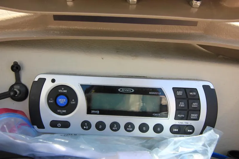 Slide: The Image of 2011 Glastron GLS 215 boat stereo system with control panel and buttons. - 16