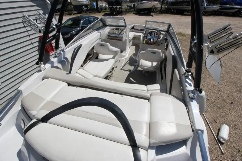 Slide: The Image of 2011 Glastron GLS 215 boat interior with white seating and steering console. - 22