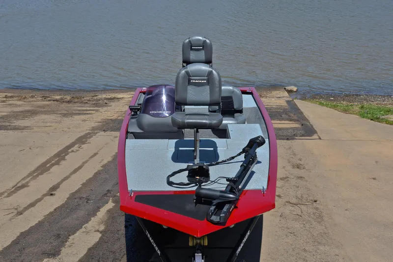 Slide: The Image of 2019 Bass Tracker Pro 170 boat at a lakeside ramp, featuring dual seats and a trolling motor. - 17