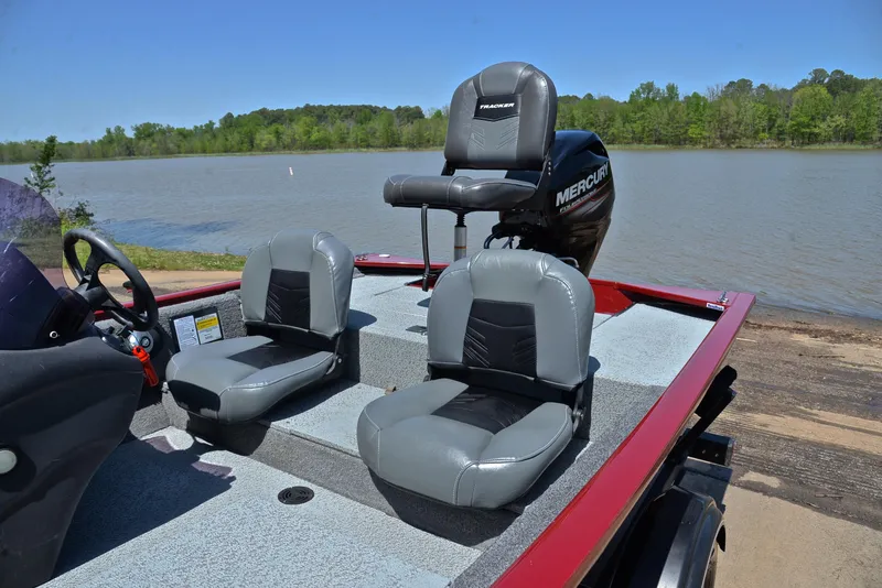 Slide: The Image of 2019 Bass Tracker Pro 170 boat with gray seats, parked by a lake. - 18