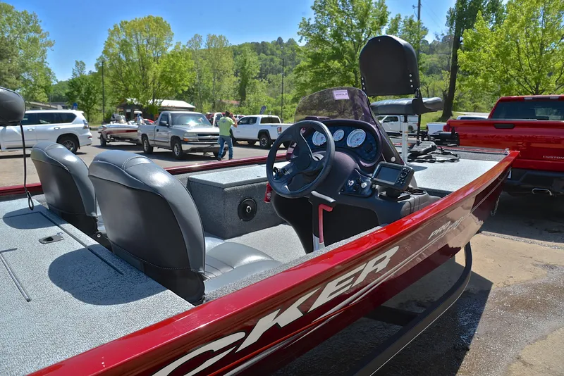 Slide: The Image of 2019 Bass Tracker Pro 170 boat with dual seats and steering console, parked outdoors. - 19