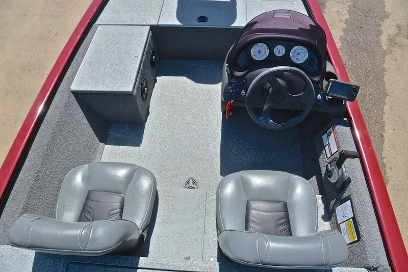 Slide: The Image of 2019 Bass Tracker Pro 170 boat interior with steering console and two gray seats. - 24