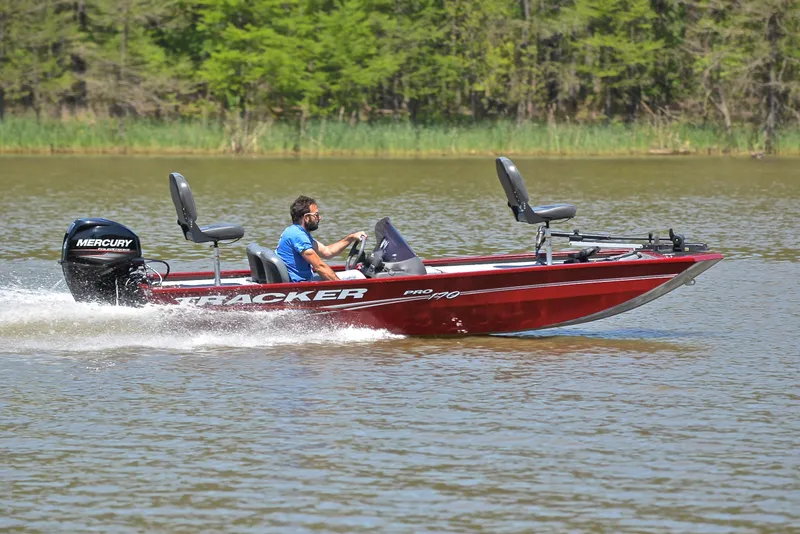 Slide: The Image of 2019 Bass Tracker Pro 170 boat speeding on a lake with a Mercury engine. - 3