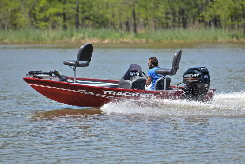 Slide: The Image of 2019 Bass Tracker Pro 170 boat speeding on a lake with a Mercury engine. - 4
