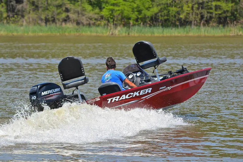 Slide: The Image of 2019 Bass Tracker Pro 170 boat speeding on a lake with Mercury engine. - 5