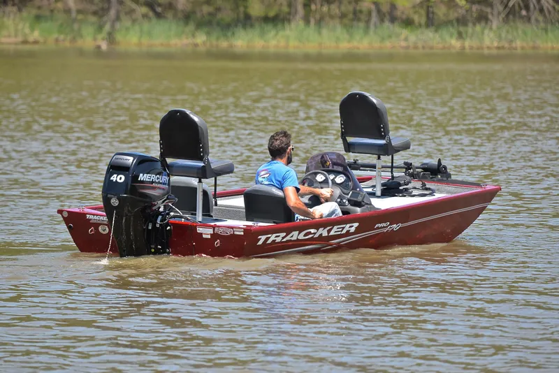 Slide: The Image of 2019 Bass Tracker Pro 170 boat on a lake with Mercury engine. - 8