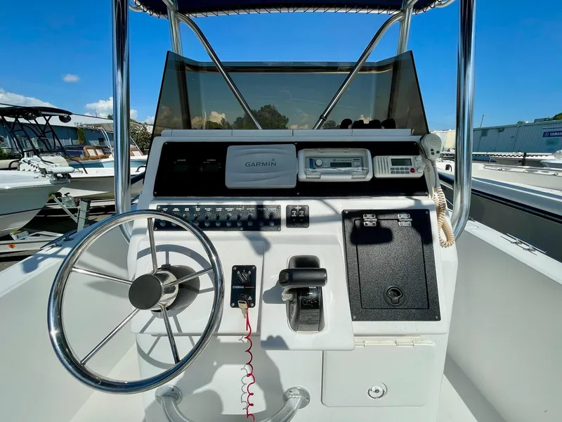 Slide: The Image of Control console of a 2002 Seastrike 240 boat with steering wheel and navigation equipment. - 10