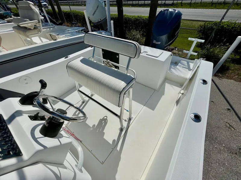 Slide: The Image of 2002 Seastrike 240 boat interior with steering wheel and seating area. - 12