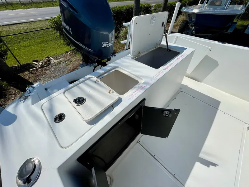 Slide: The Image of 2002 Seastrike 240 boat deck with Yamaha outboard motor and storage compartments. - 14