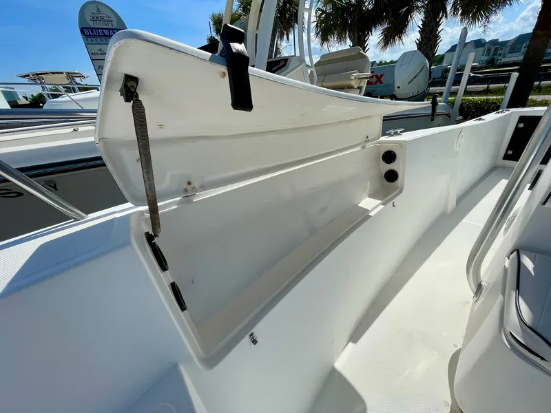 Slide: The Image of 2002 Seastrike 240 boat interior with open storage compartment, showcasing sleek white design. - 16