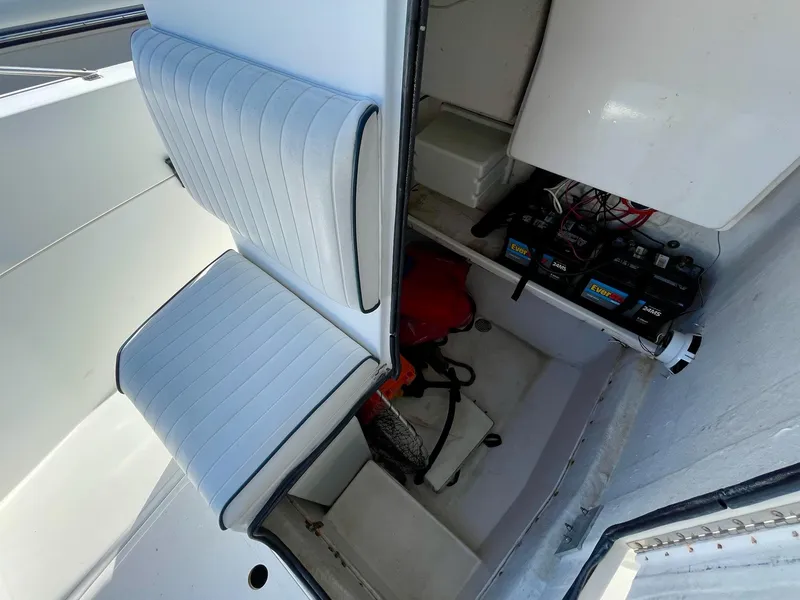 Slide: The Image of Interior view of a 2002 Seastrike 240 boat showing seating and storage compartments. - 17