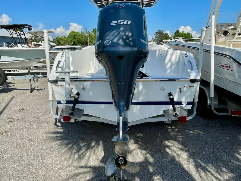 Slide: The Image of 2002 Seastrike 240 boat with a 250 HP outboard motor, parked on a trailer. - 4