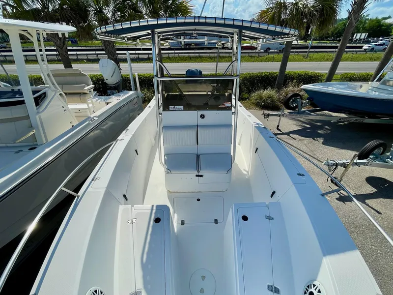 Slide: The Image of 2002 Seastrike 240 boat with center console, docked outdoors, surrounded by other boats. - 6