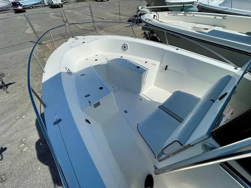 Slide: The Image of 2002 Seastrike 240 boat deck with seating, white interior, and railing. - 7