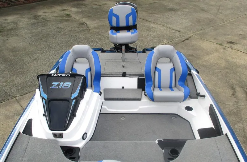 Slide: The Image of 2025 Nitro Z18 boat interior with blue and gray seating, showcasing modern design. - 10