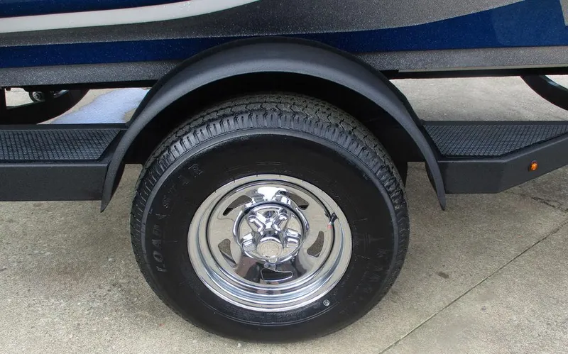 Slide: The Image of Trailer wheel of a 2025 Nitro Z18 boat, featuring chrome rim and black tire. - 9