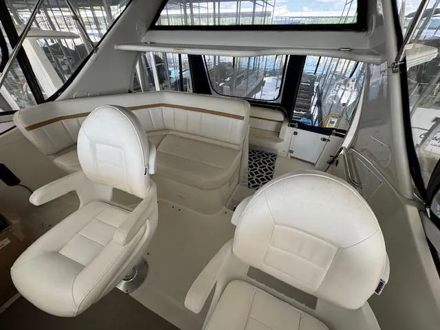 Slide: The Image of 2006 Carver 36 Motor Yacht interior with white seating and panoramic windows. - 19