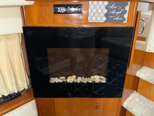 Slide: The Image of 2006 Carver 36 Motor Yacht interior with modern fireplace and decorative sign. - 27