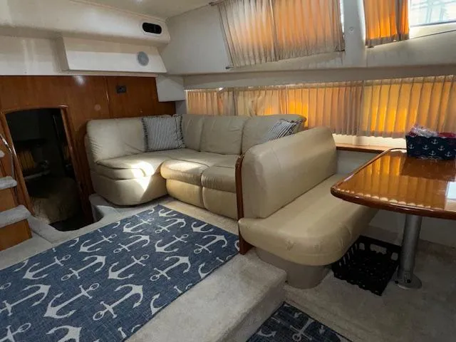 Slide: The Image of Interior of 2006 Carver 36 Motor Yacht with beige seating and nautical-themed decor. - 29